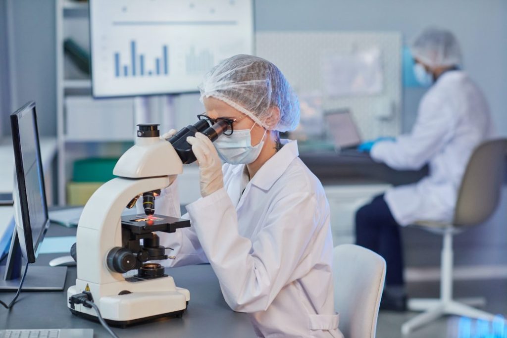 woman holding research at the laboratory by Atlanta Dermatopathology
